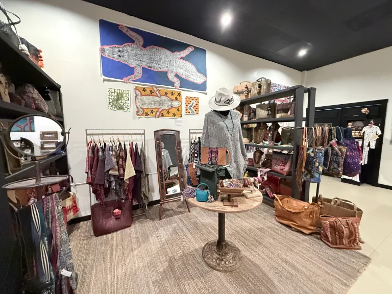 Accessories and clothing displayed among artwork and gifts inside Ghost Orchid Studio
